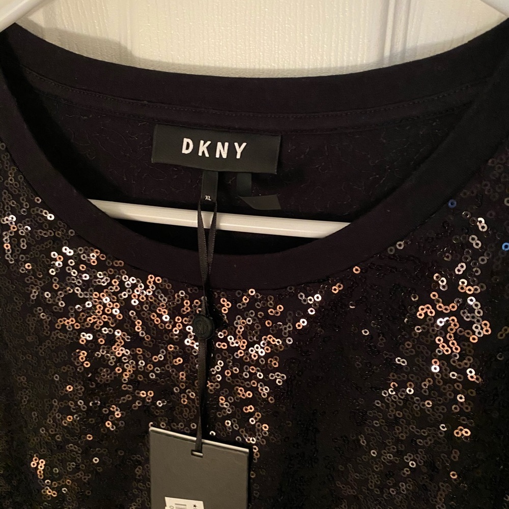 Black sequins shirt. Short sleeve. Never worn.